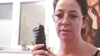 Tattooed brunette with glasses plays with her tampoo