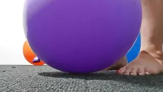 Women Stomping on balloons to pop them