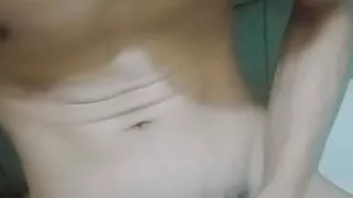 The skinny guy shakes his dick again in the bathroom