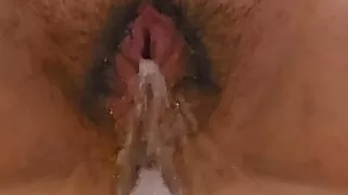 Hairy fat pussy urinating in the bathtub
