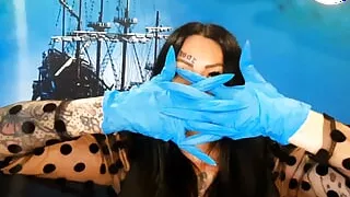 Glove fetish. Dominatrix Nika puts on medical gloves and tears them with her long nails. Latex gloves