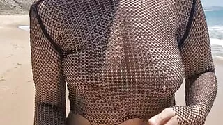 On a public beach, while walking in a transparent blouse, I meet a stranger