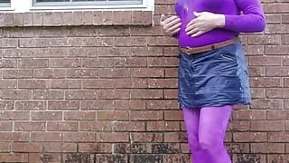 Crossdressed outdoors in nylon bodysuit getting wet in the rain.