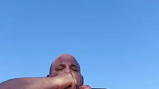 Fat guy strokes his thick cock outside
