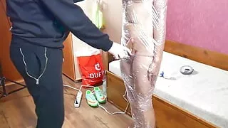 Horny twink wrapped in a foil and duct taped