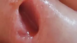 A large load of his friend accumulated in the condom for the boy to play with.