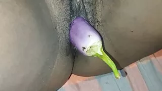 My tight pussy is being pampered with a brinjal. It hurts a bit