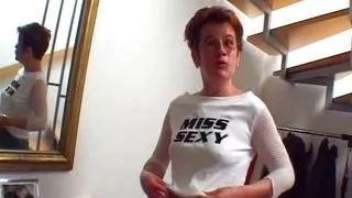 Attractive German MILF stuffs her cunt with a big dildo on the stairs