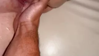 Horny girl squirts during fingering her tight pussy