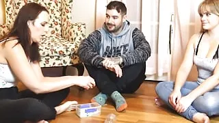 Playing spin the bottle strip game with two sexy girls and a tattooed guy