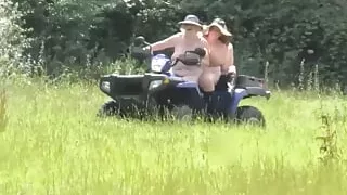 Crazy Naked Matures in floppy hats on a Quad bike
