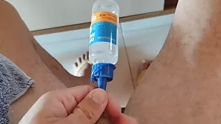 The gelatinous serum is being introduced into the young man's cock quickly.