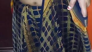 My wife is wearing a sari in her room.