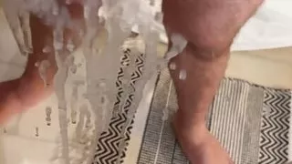 Hairy Bear jerks off in front of a mirror and cums all over it