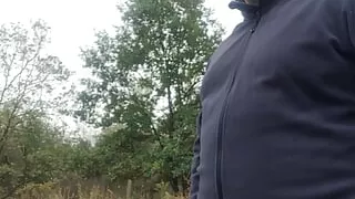 mastrubbing  bear  a small cock next to a parking lot