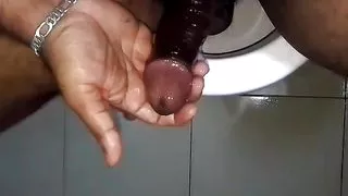 Guy Squeezing his oiled up pink cock head while jerking off and cum slowly.