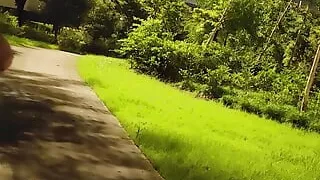 Nude walking in a park on the side of a busy highway and peeing