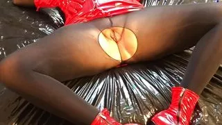 Red fetish dress, black pantyhose, ankle boots and dildo