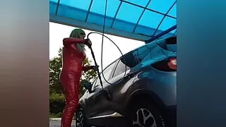 At the car washing station in red vinyl outfit
