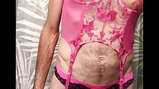 Crossdresser sucking on a dildo teasing ass while wearing sexy pink Lingerie