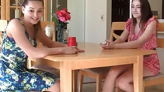 A strip Liars Dice game ends with both girls satisfying each other on the bed