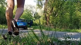 I clean the windows of my car on the side of the road in a minidress with an anal plug