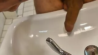 He pisses in the sink with his huge cock