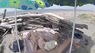 On a nudist beach in Tenerife, the stepdaughter jerks off her stepfather's cock without shame