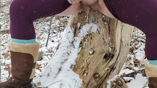 Peeing up against a tree in winter