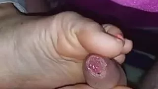 Secret footjob under blanket to