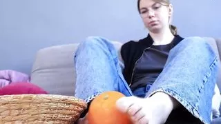 Sexy barefoot play with orange
