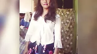 Jhazmeena wearing a white blouse and a pleated black retro flower print skirt