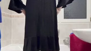 In a fine black velvet dress and nylons