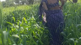 The native daughter-in-law of the village shows her beautiful son-in-law in the open air on the farm, shows her backyard, her slim waist, her tightness in the forest of the open field.