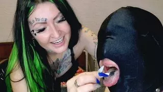 Smoking fetish. Dominatrix shakes cigarette ash on her slave's head and mouth.