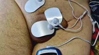 Dominatrix Nika plays with electric discharges on the genitals of the slave. Electrostimulation BDSM