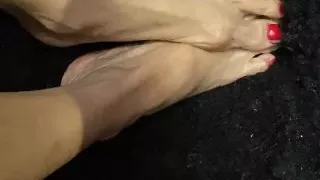 Oiled sexy tiny feet with red toenail polish