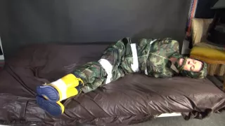 Watching Sexy Pia Being Tied And Gagged With Tape On A Bed Wearing A Sexy Camouflage Shiny Nylon Rainpants And A Rainjacket As Well As Yellow Rubber Boots (Video)