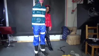 Sexy Ronja Wearing Shiny Nylon Downwear Being Tied And Hooded With Tapes From Stella On A Rack (Video)