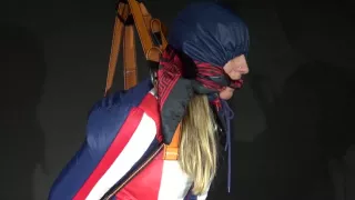 Watching Sexy Sandra Wearing A Sexy Oldschool Downbib And A Down Jacket Being Suspended, Tied, Gagged And Hooded With Ropes And A Ballgag (Video)