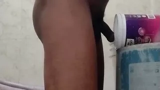 Cex from mug in bucket in bathroom