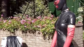 Leather woman gets dominated outdoor