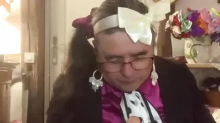 In an outfit with a little black skirt to suck a dildo