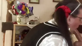 In an outfit with a schoolgirl-style wool dress to suck Marcel the inflatable doll with his hands tied behind his back