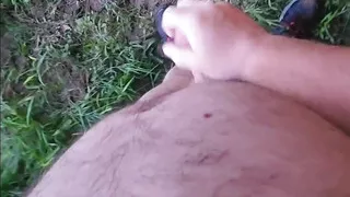 Naked outside under a bridge.