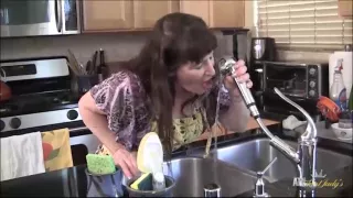 Anna plays with herself in the kitchen.