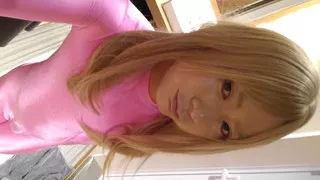A blonde cross-dressing boy masturbated in pink full-body tights and long gloves.