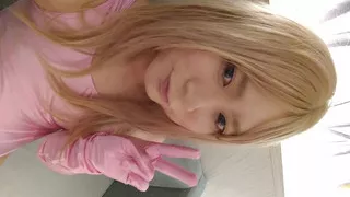 A blonde cross-dressing boy masturbated in a pink leotard, knee socks and gloves