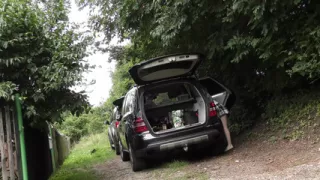 Hot redhead in short skirt loads a car