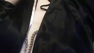 The bitch is fucking her cunt deeply with a hard glass dildo